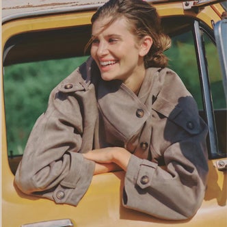 Anthropologie; a woman wearing Maeve Funnel-Neck Short Trench Coat against a natural background