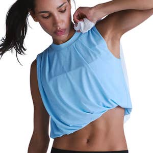 A woman wearing a light blue Free People Tempo Twist Me Up UV Protection Tank against a white background