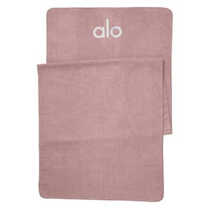 A pink Alo Yoga Grounded No-Slip Towel against a white background