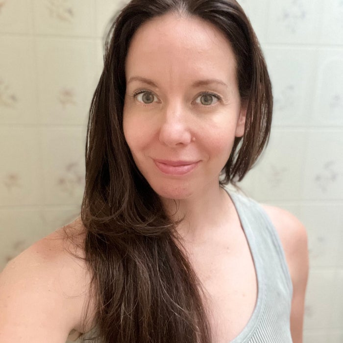 Brittany wearing a gray tank top against an off white background