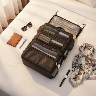 Amazon; A packing organizer and accessories on a white bed