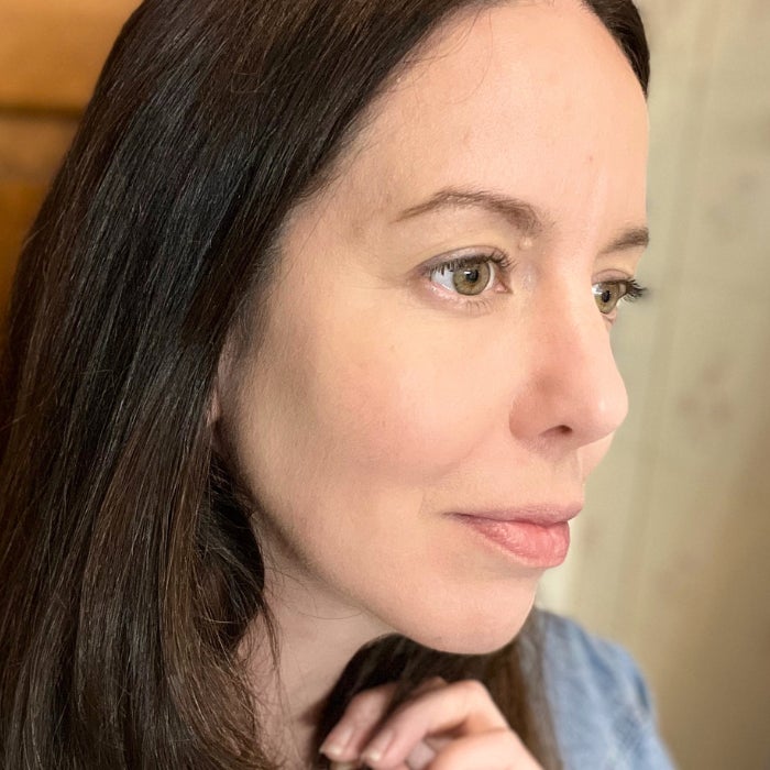 A profile view of a woman's face against a natural background