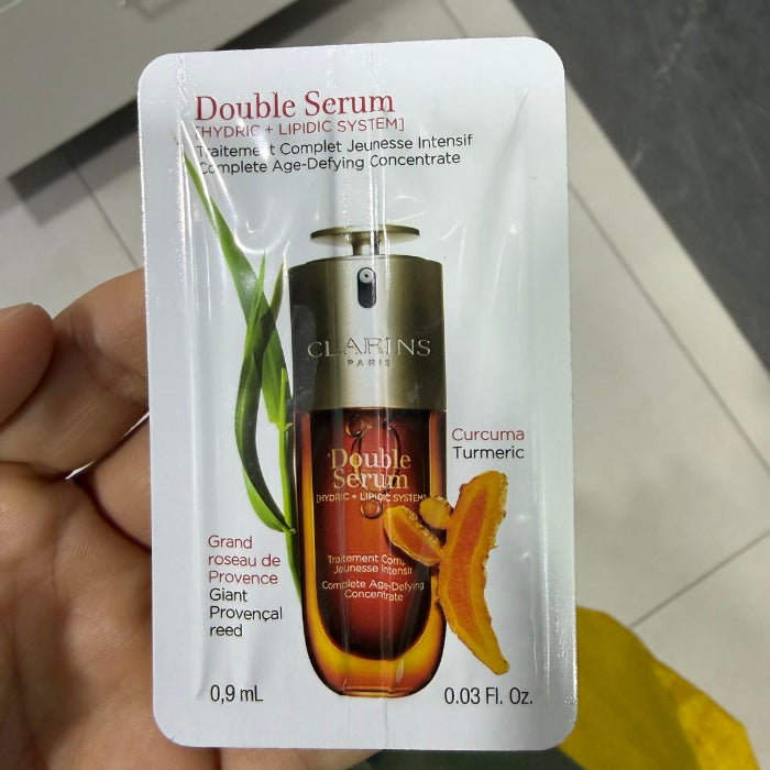 a sample packet of Clarins Double Serum against a natural background