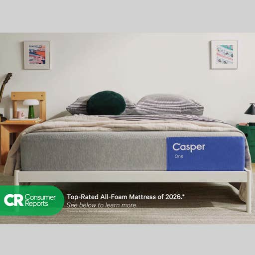 a casper mattress on a white bedframe against a neutral colored wall