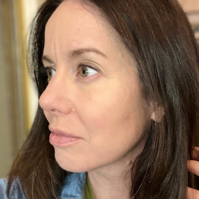A profile view of a woman's face against a natural background