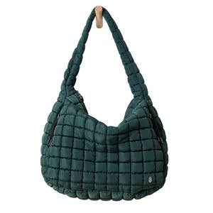 A dark green FP Movement Quilted Carryall Bag against a white background