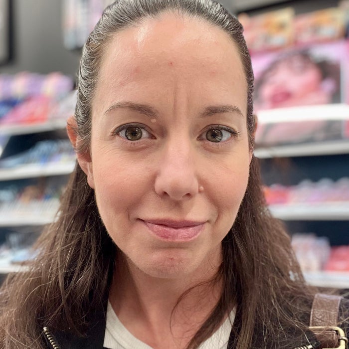 Brittany Brainard's face before applying LAWLESS Forget The Filler Lip Plumper Line Smoothing Gloss against a natural background