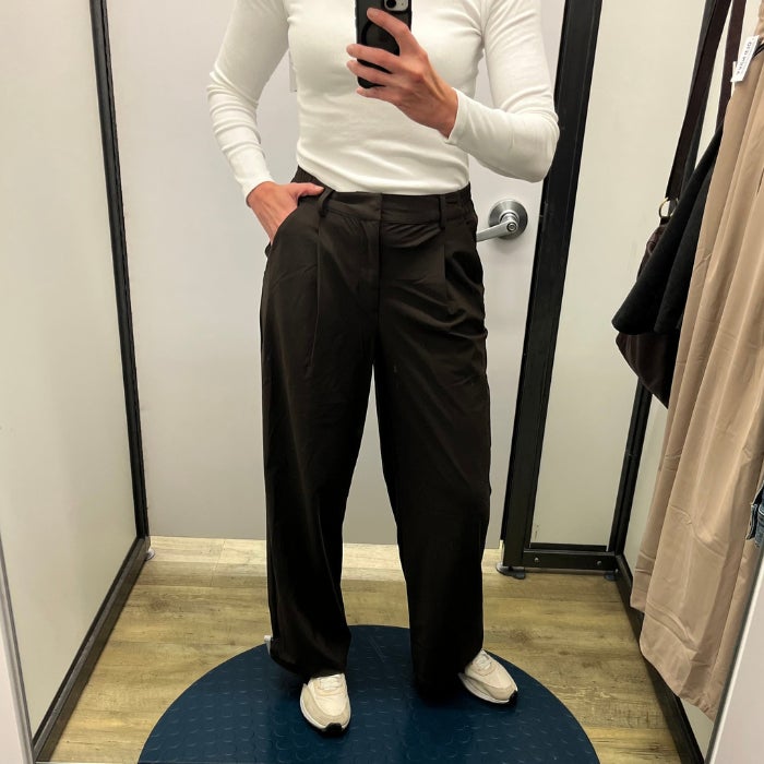 a woman wearing Old Navy High-Waisted SleekTech Trouser Pants against a natural background