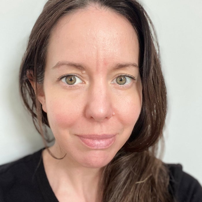Brittany Brainard's face before applying Maybelline Lip Lifter Gloss against a white background