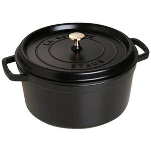 black round cast iron dutch oven with lid on white background