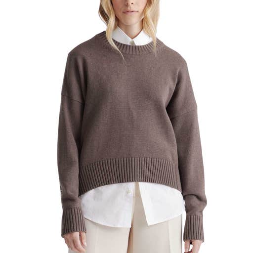 A woman wearing a Quince 100% Organic Cotton Boyfriend Crew Sweater against a white background