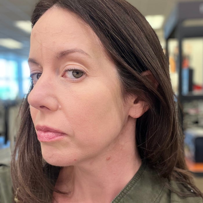 A profile view of a woman's face against a natural background