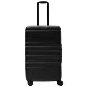 all black medium check-in roller luggage on white background