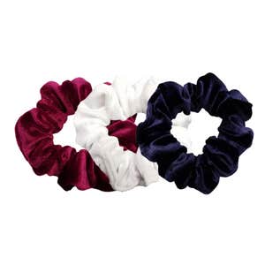 Three velvet hair scrunchies against a white background