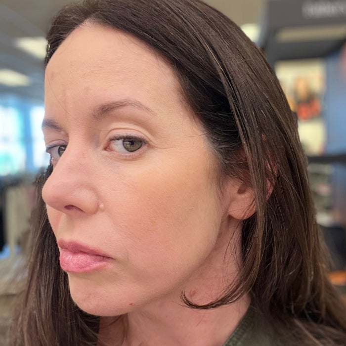 A profile view of a woman's face against a natural background